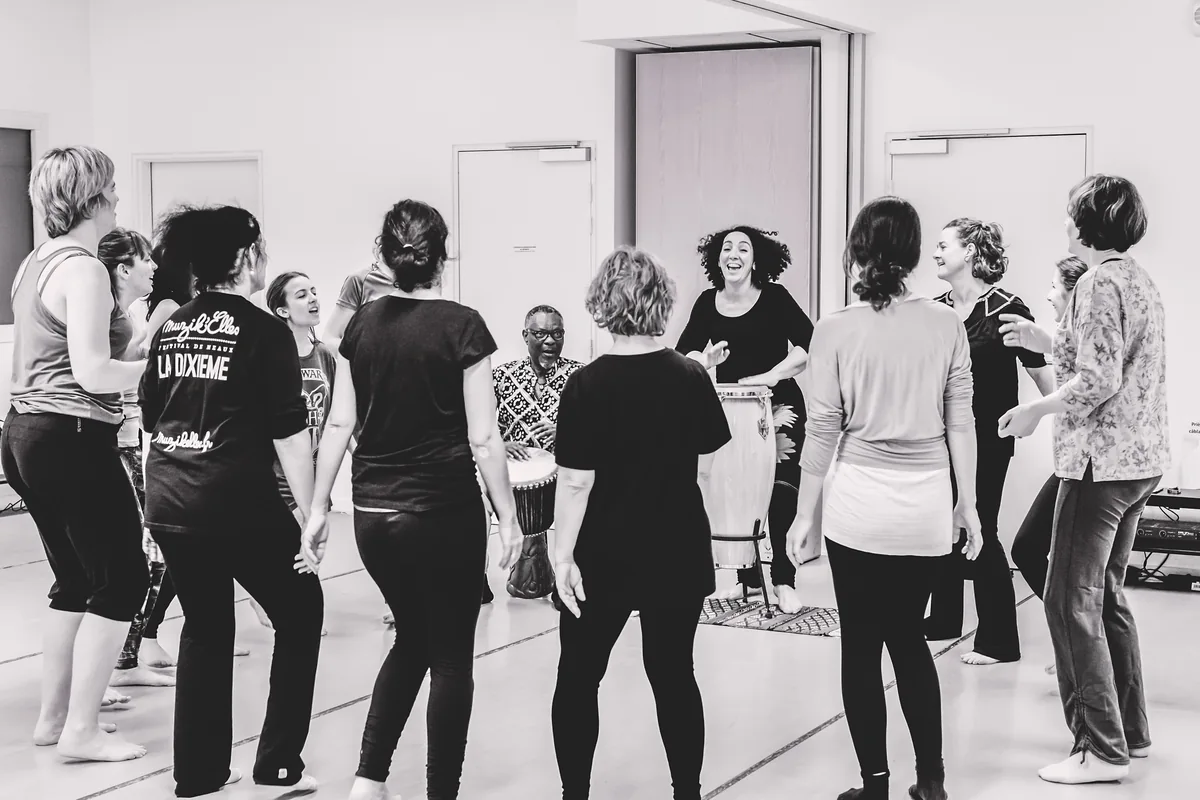 Groupe en cercle lors d'un atelier Expression Primitive avec percussionniste